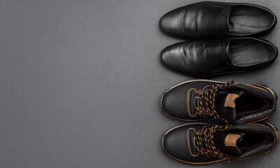 Different men's shoes on black. Top view. Space for text.