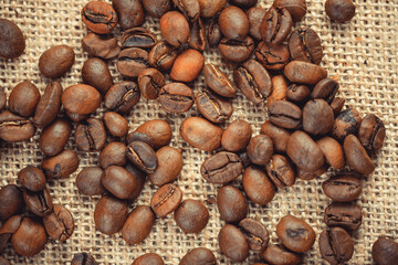 Roasted coffee beans on burlap. Background for coffee shops and store websites