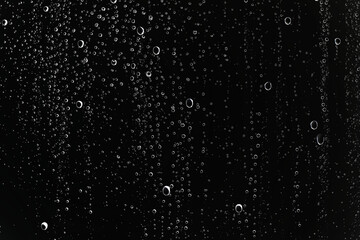 black wet background / raindrops for overlaying on window, concept of autumn weather, background of drops of water rain on glass transparent