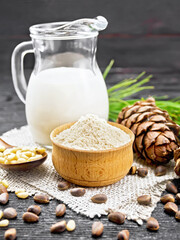 Flour cedar in bowl with nuts on wooden board