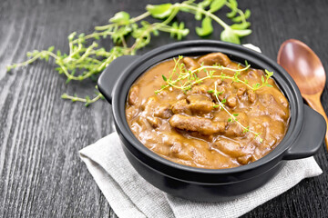 Goulash of beef in pan on wooden board