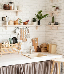 Rustic kitchen interior with white brick wall and white wooden shelves