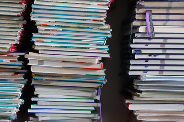  Stacks of old discarded school textbooks waiting to be disposed of in a school library.
