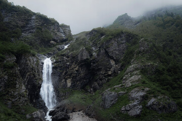Moody Waterfall in the green mountains covered in mist