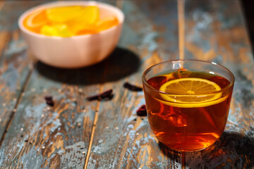 Transparen lemon tea cup with slice of lemon on a wood rustic table