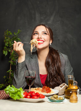 Happy Woman Enjoying Pasta In Restaurant