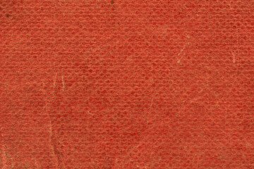 The texture of the old book cover is orange. Grunge background, worn vintage surface