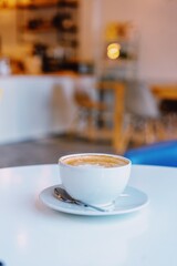 Beautiful latte art cup inside the modern cafe