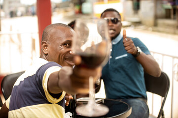 young group of friends holding a glass of red wine