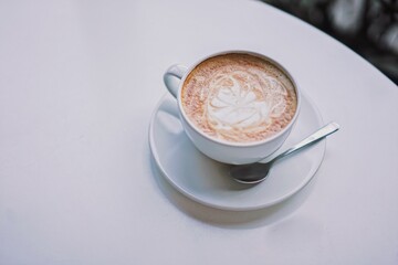 Beautiful cup of latte with copy space on the white table