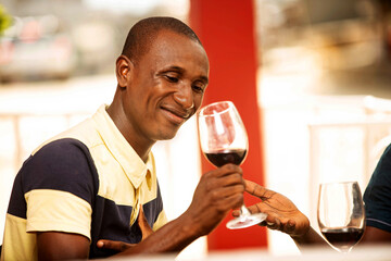 handsome young man drinking a glass of red wine
