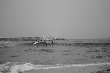 surfers riding waves in the ocean