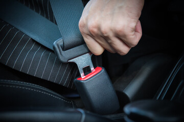 Hand fastening seat belt in the car