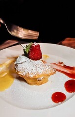 custard dessert with strawberry served on white plate
