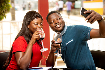 young romantic couple outside a refreshment room with mobile pho