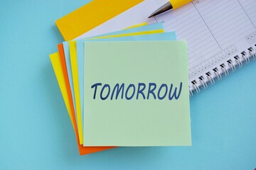 Procrastination, delay and urgency concept. Bad time management. Word TOMRROW on colorful sticky...
