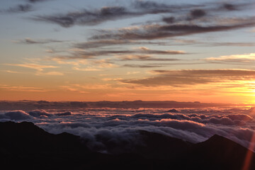 a sunset over a mountain range