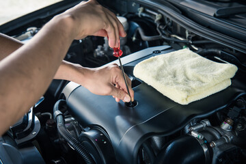 Obraz na płótnie Canvas Car service ,fitting a car battery with wrench