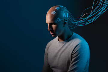 man with electrodes in his head is a futuristic concept of virtual reality and mind control.