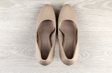 Beige women's shoes on a light background. Women's shoes with heels