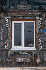 Old wooden window frame with decorative handmade architectural details