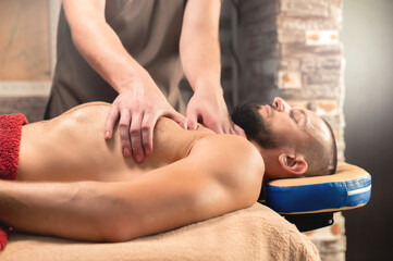 Close-up medical sports massage of the chest and pectoral muscles.