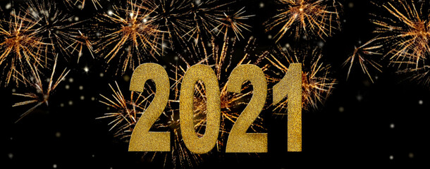 2021  golden figures with glitters  on bright fireworks background