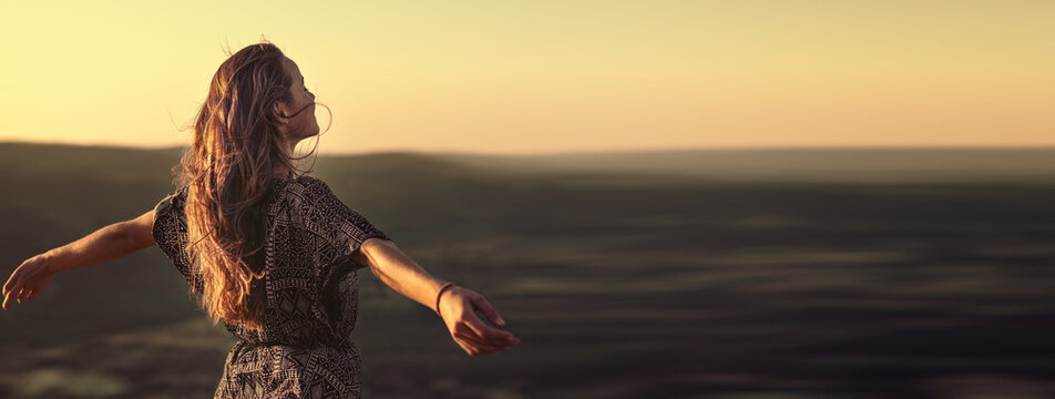 Christian Worship And Praise. A Young Woman Is Praying And Worshiping In The Evening. Worship And Prayer Banner.