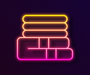 Glowing neon line Towel stack icon isolated on black background. Vector.