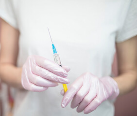 
Girl holding a syringe with a coronavirus vaccine in her hand