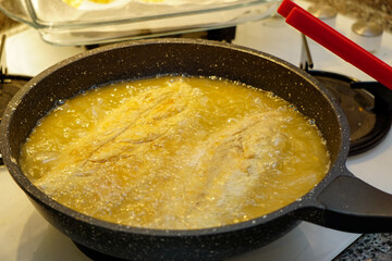 Oil Roasted bonito fish preparation in the kitchen on the oven candid image