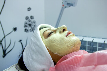 young woman in mask in spa salon