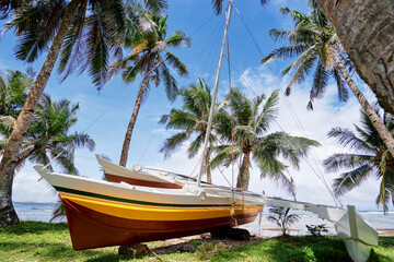 Fototapeta na wymiar Beautiful landscape - tropical coconut palms beach with fishing boat. Siargao Island, Philippines.