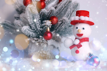 Cute snowman and Christmas decoration, bokeh effect
