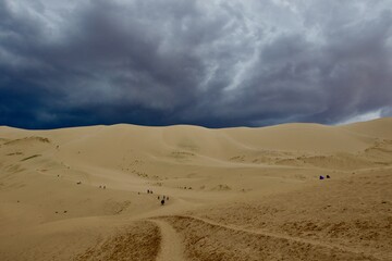 Fototapeta na wymiar Dramatic sky over Gobi desert sand dunes, Mongolia 