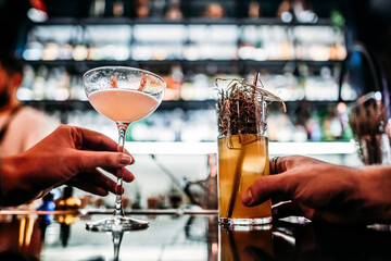 cocktail for a girl and a man stand on the bar table