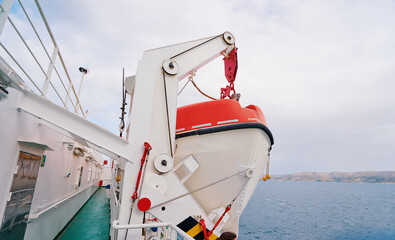 Transportation and safety. Lifeboat on ferry deck.