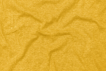 Cotton textile fabric background toned in Fortuna Gold, colour 2021