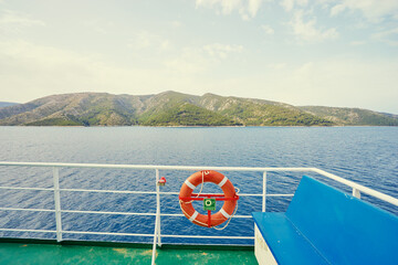 Red Lifebuoy in front of the blue sea on the ship