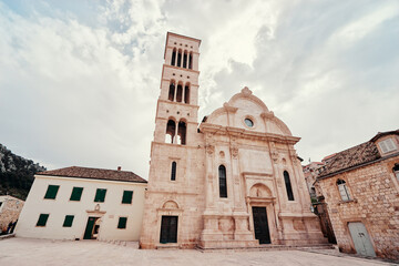 Fototapeta premium Fascinating fortified church of St. Mary with bell tower on the square of Hvar Old Town, Croatia.