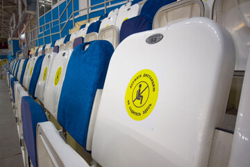 locked chairs at the stadium during the pandemic keep your distance don't sit here