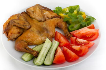 Fried chicken with vegetables on a white plate