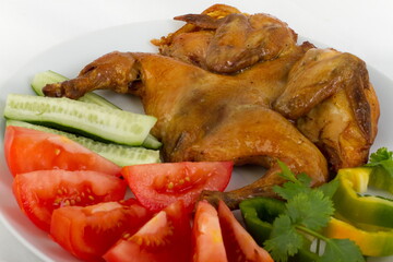 Fried chicken with vegetables on a white plate