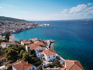 Aerial shot of Spetses Island coast in Greece. A famous tourist destination on the Aegean sea. Old town and harbour view.