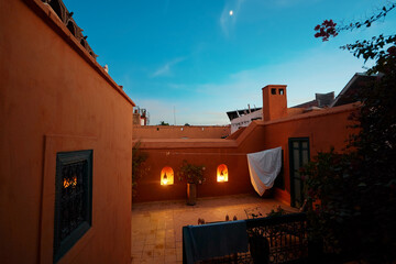Arabian night. Traveling by Morocco. Relaxing in festive moroccan traditional riad terrace in...
