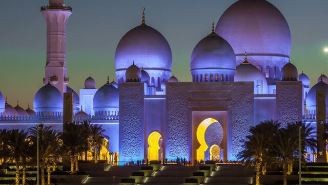 Sheikh Zayed Grand Mosque in Abu Dhabi day to night transition timelapse after sunset, UAE. Evening view from Wahat Al Karama