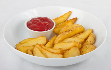 Fried potato slices with ketchup