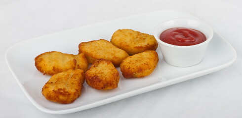 Six slices of chicken nuggets with ketchup