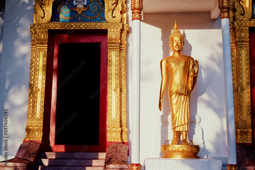 Wall mural Golden statue of Buddha in thai temple.