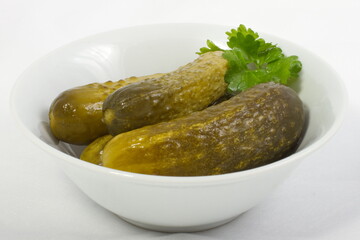 Pickled cucumbers in a white bowl
